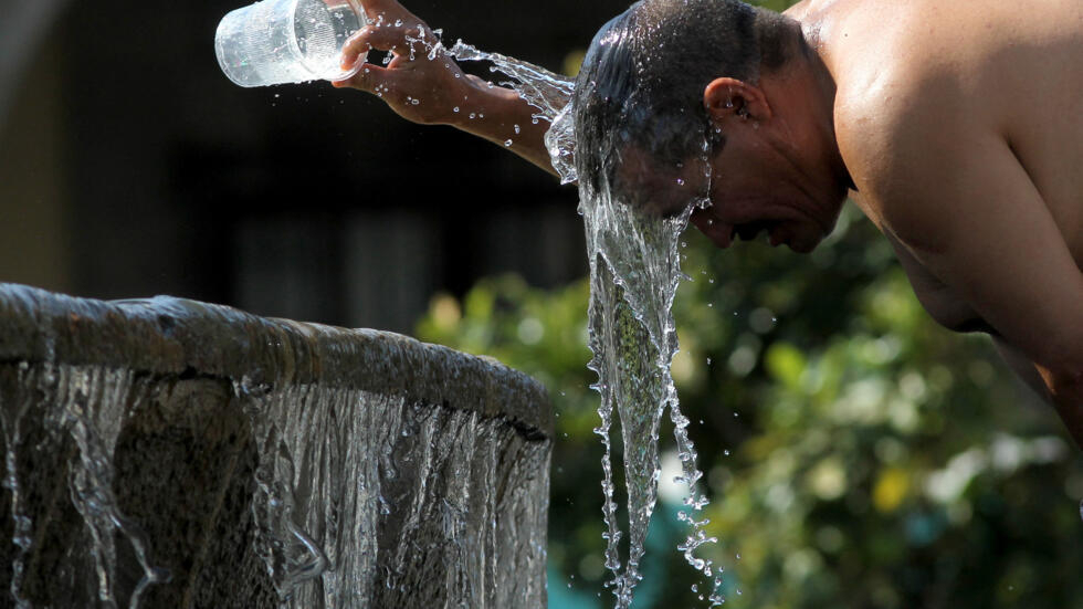 A man cools himself down with water from a fountain during one of the hottest days of the third heat wave in Guadalajara, Jalisco state, Mexico, on June 12, 2023. 