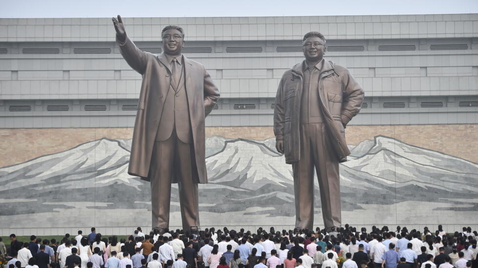 People visit the statues of the late North Korean leaders Kim Il Sung and Kim Jong Il on the 29th anniversary of Kim Il Sung's death at Mansu Hill in Pyongyang on July 8, 2023.