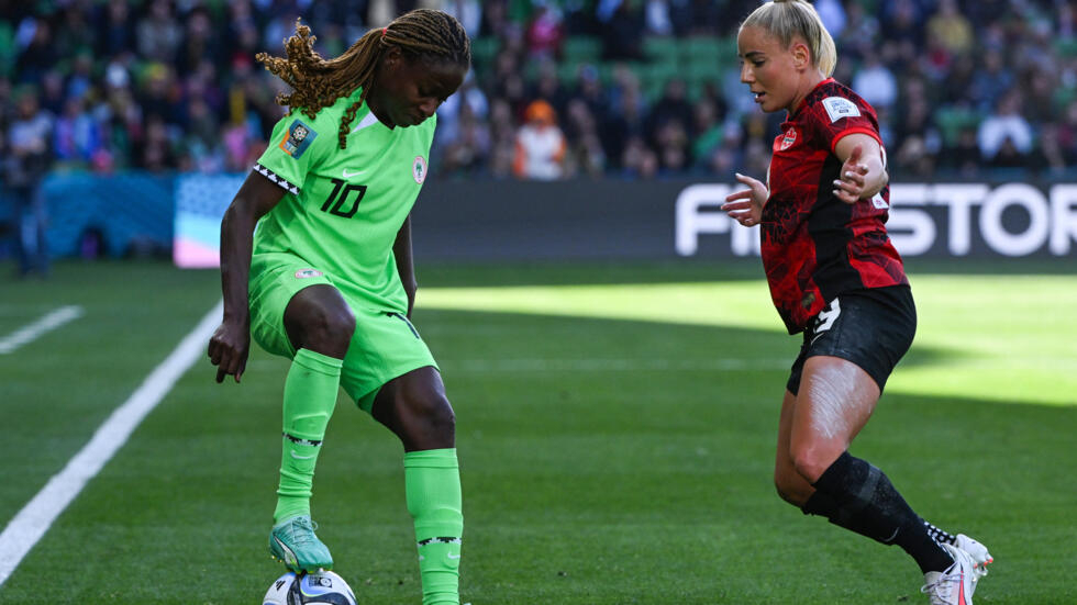 Nigeria's midfielder #10 Christy Ucheibe and Canada's forward #19 Adriana Leon fight for the ball during their teams’ 2023 Women's World Cup Group B football match at Melbourne Rectangular Stadium, also known as AAMI Park, in Melbourne, Australia on July 21, 2023.