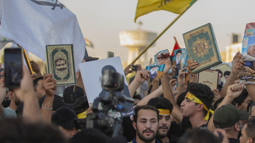 Iraqis raise copies of the Koran during a protest in Tahrir Square in Baghdad on July 20, 2023 .